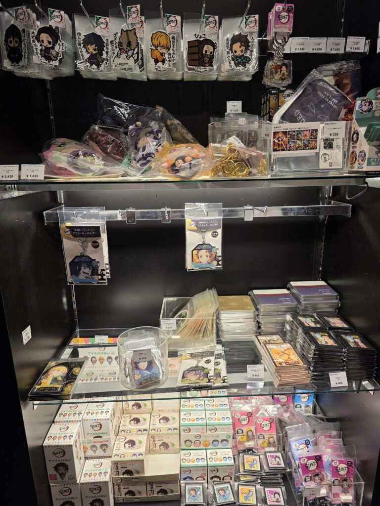 Keychains, stickers, and small Kimetsu no Yaiba goods on display