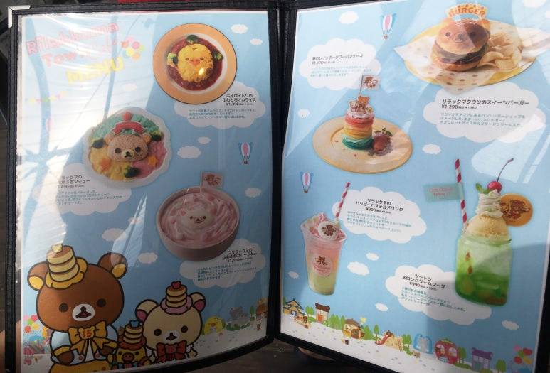Rilakkuma-themed food and drink menu at the character café in Osaka, including omurice, desserts, and colorful drinks