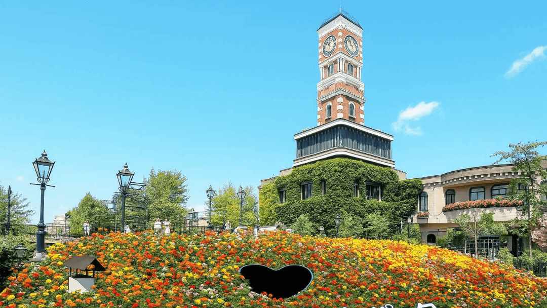A fairytale-like view of Shiroi Koibito Park in Sapporo, featuring its iconic clock tower, colorful flowerbeds, and European-style architecture