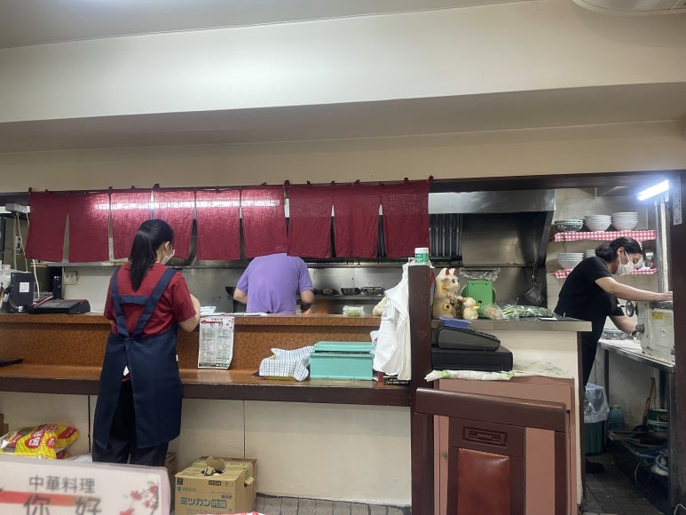 Inside view of the kitchen at Nihao, showing staff preparing food