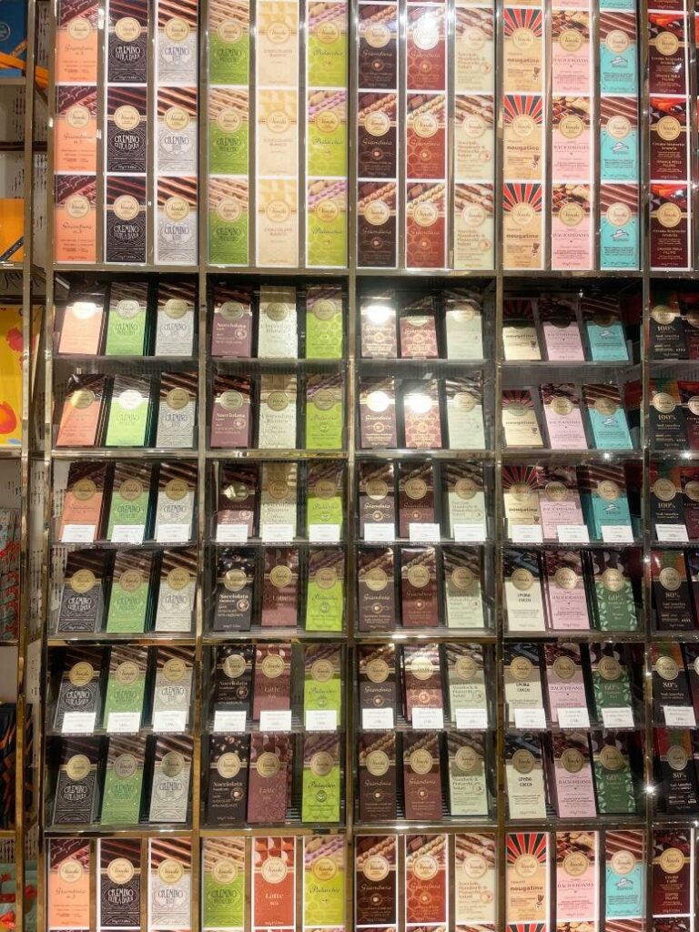 Colorful Venchi chocolate bars stacked on display shelves