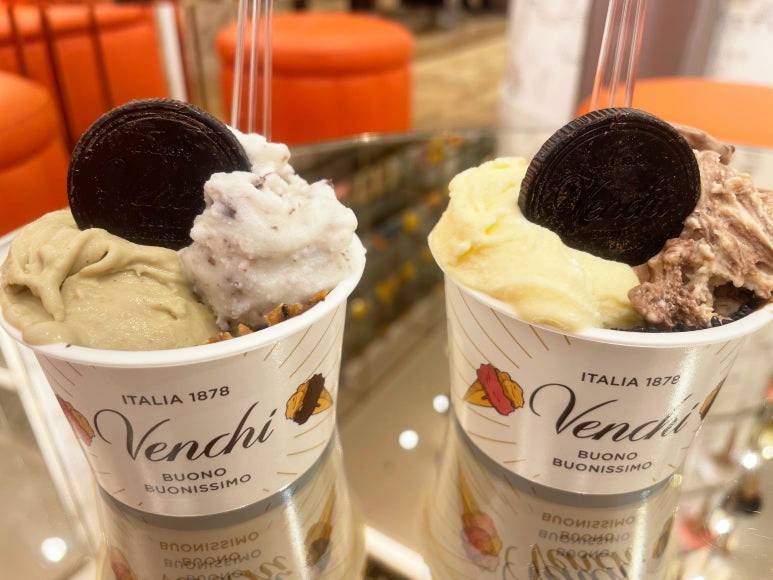 Close-up of two Venchi gelato cups with chocolate medallions