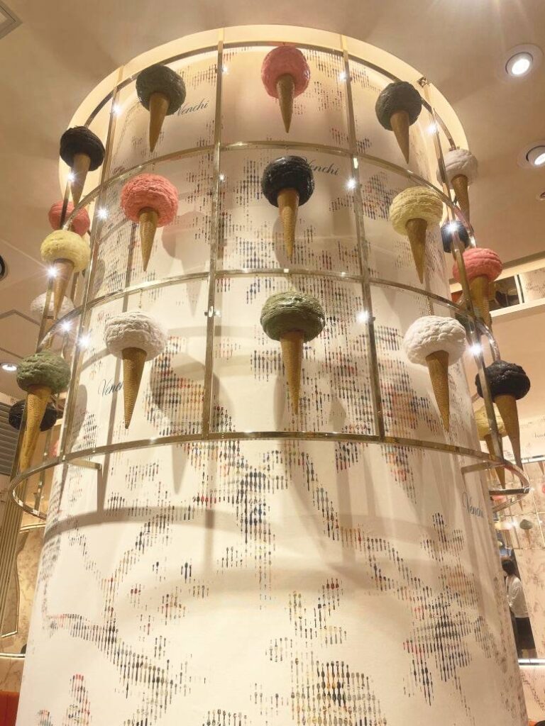 Giant cone-shaped gelato models on a central pillar inside store
