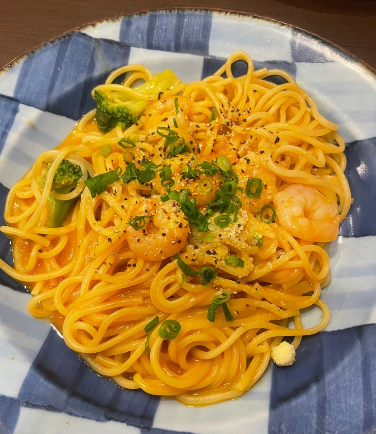 Rich lobster sauce pasta topped with plump shrimp and green onions, served at Kamakura Pasta