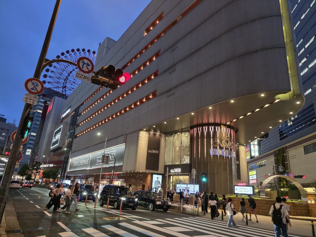 Exterior wide shot of the Hankyu Umeda Men's Building with TOHO Cinemas, taken from across the crosswalk
