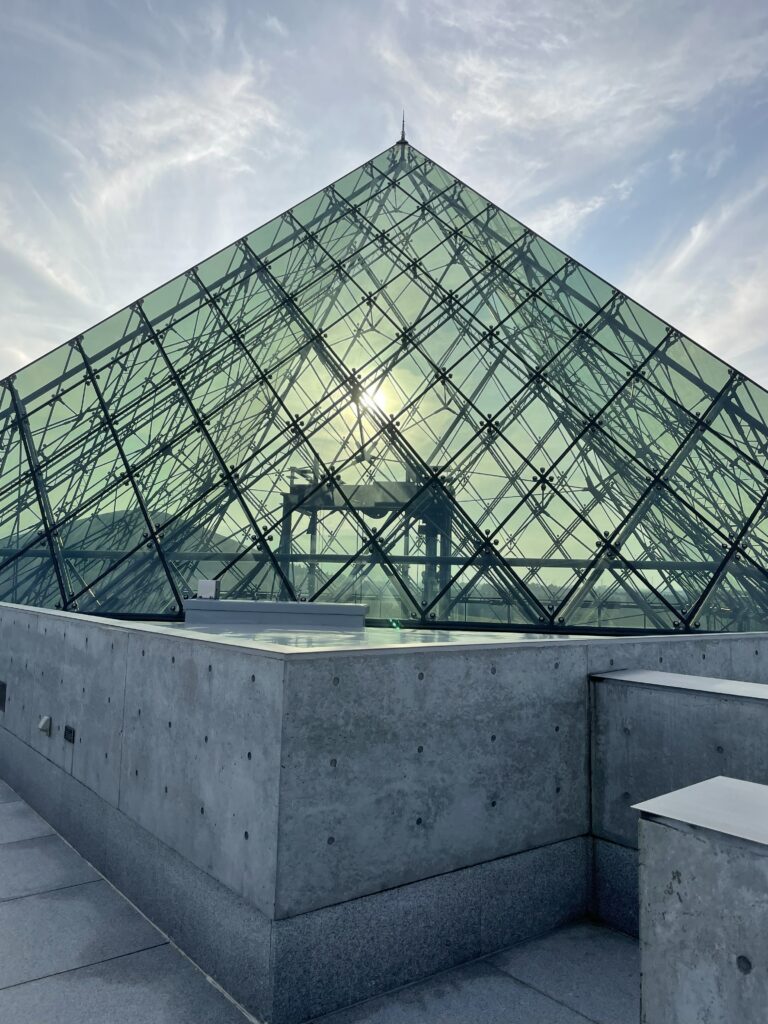 Rooftop view of the Glass Pyramid HIDAMARI with sunset reflection, Moerenuma Park in Sapporo, Hokkaido