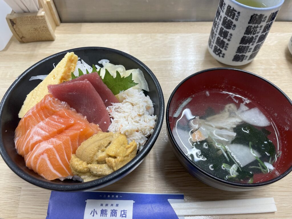 A beautifully arranged kaisendon served with clear seafood soup at a local restaurant in Nijo Market, Sapporo