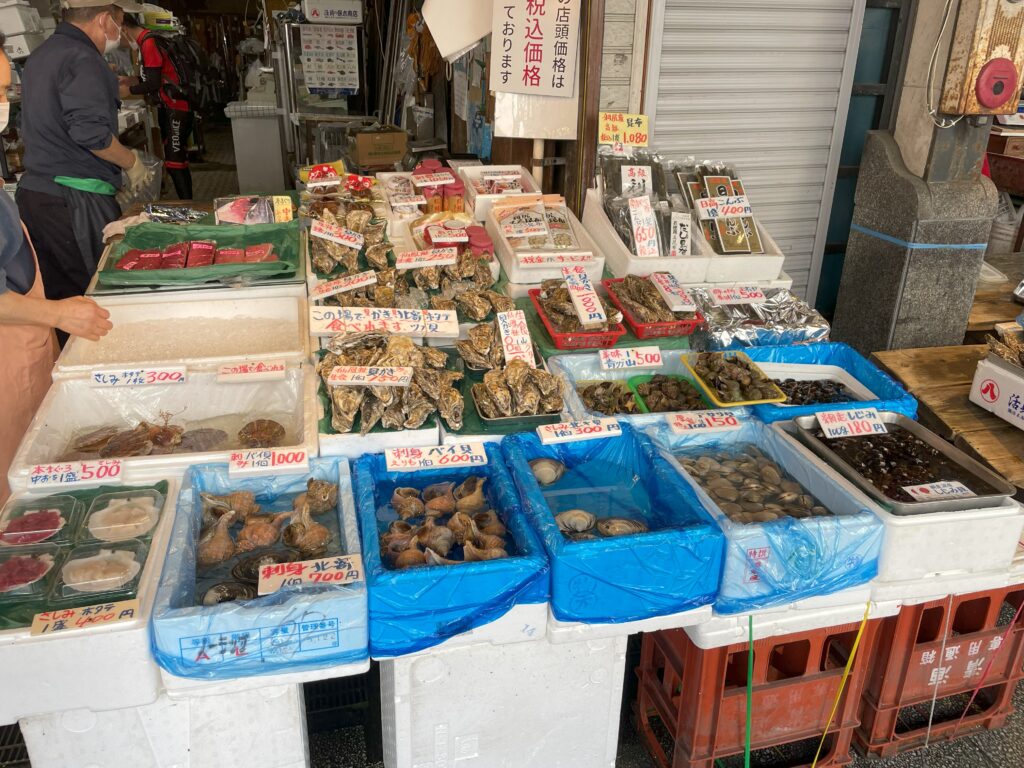 A vibrant selection of fresh oysters, scallops, and snails at one of the many seafood stalls in Nijo Market, Sapporo, Hokkaido