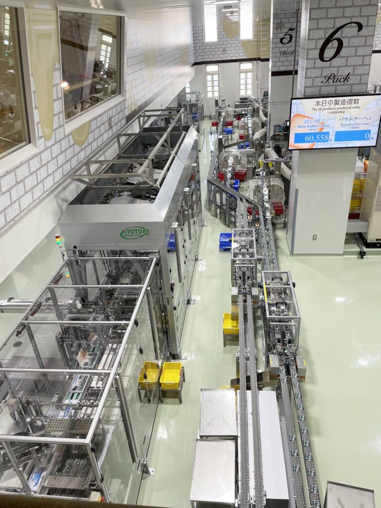 Shiroi Koibito cookies being packaged at the end of the production line in the factory tour area.