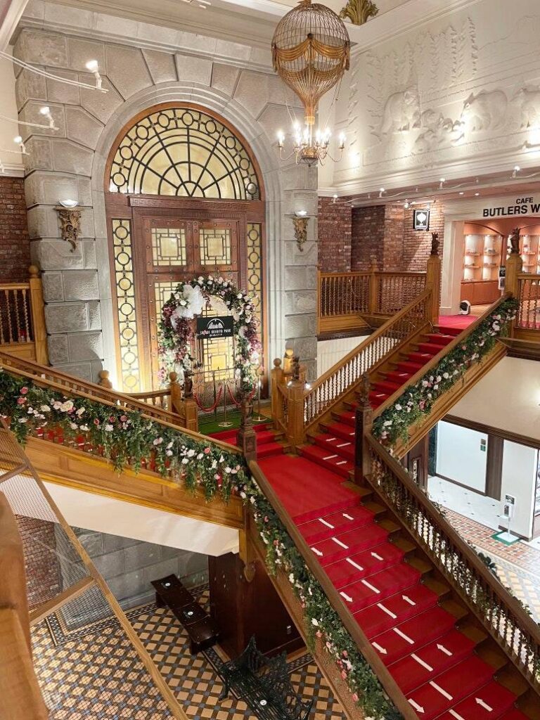 Elegant red-carpet staircase and floral decorations inside Shiroi Koibito Park in Sapporo, Hokkaido.