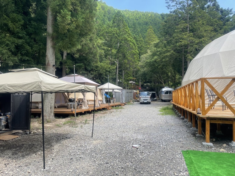 Glamping tents lined up on both sides of the entrance