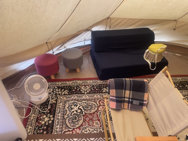 Small stool and fan on the left side of the tent