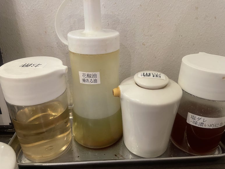 Table condiments including vinegar, huajiao, black vinegar, and salt sauce at 8ppy Mala Tang, Osaka Namba Parks