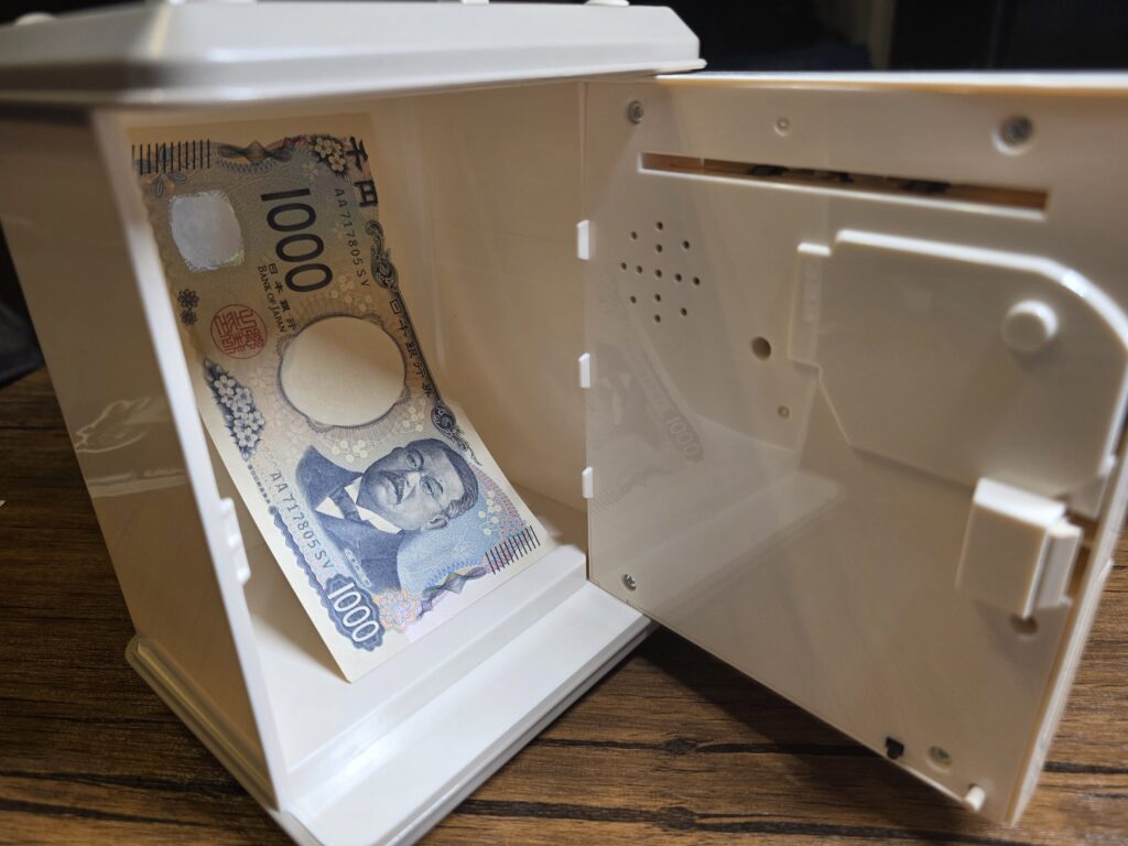電子貯金箱の中に入れた日本の1,000円札