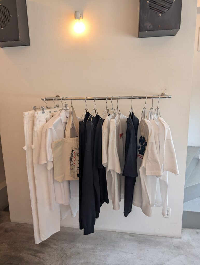 Merchandise including apparel and bags at Henry’s Pizza