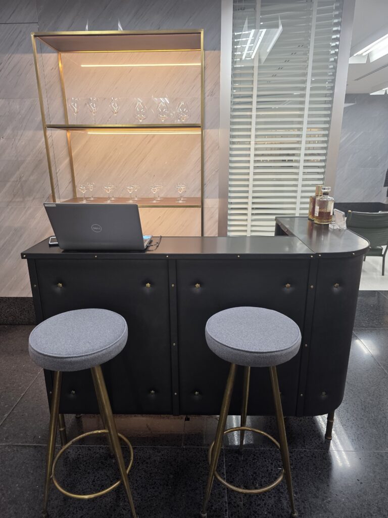 Counter area with whisky and a laptop at the bar