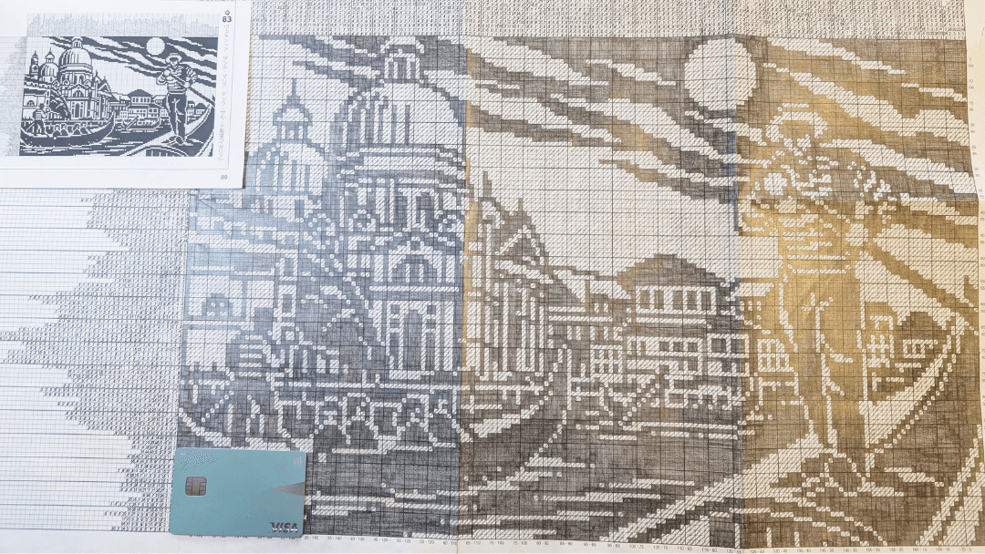 Completed Super Ultra Jumbo nonogram puzzle depicting large buildings and a human figure