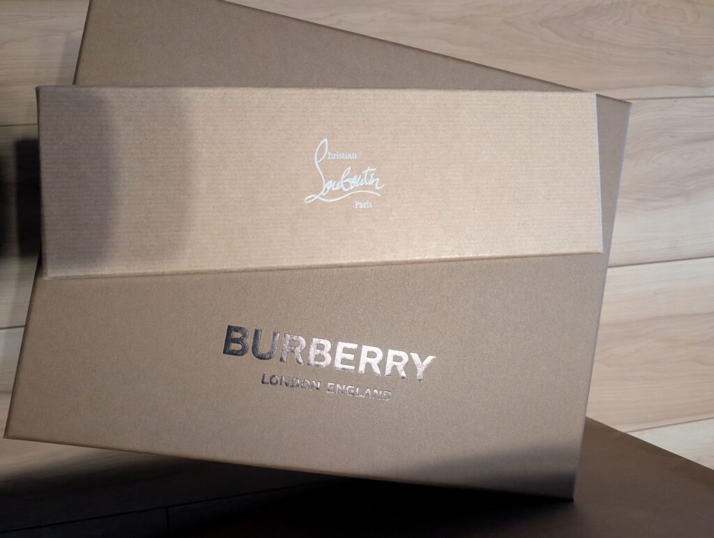 Luxury brand boxes from Burberry and Christian Louboutin